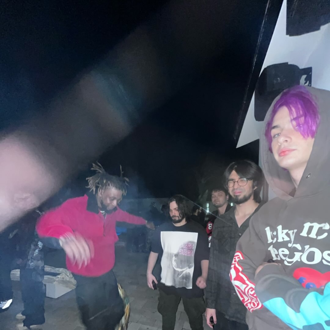 traphousepunk and friends at a house show at night, shot on flash with heavy motion blur
